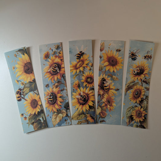 Five sunflower bookmarks with bees on a white background
