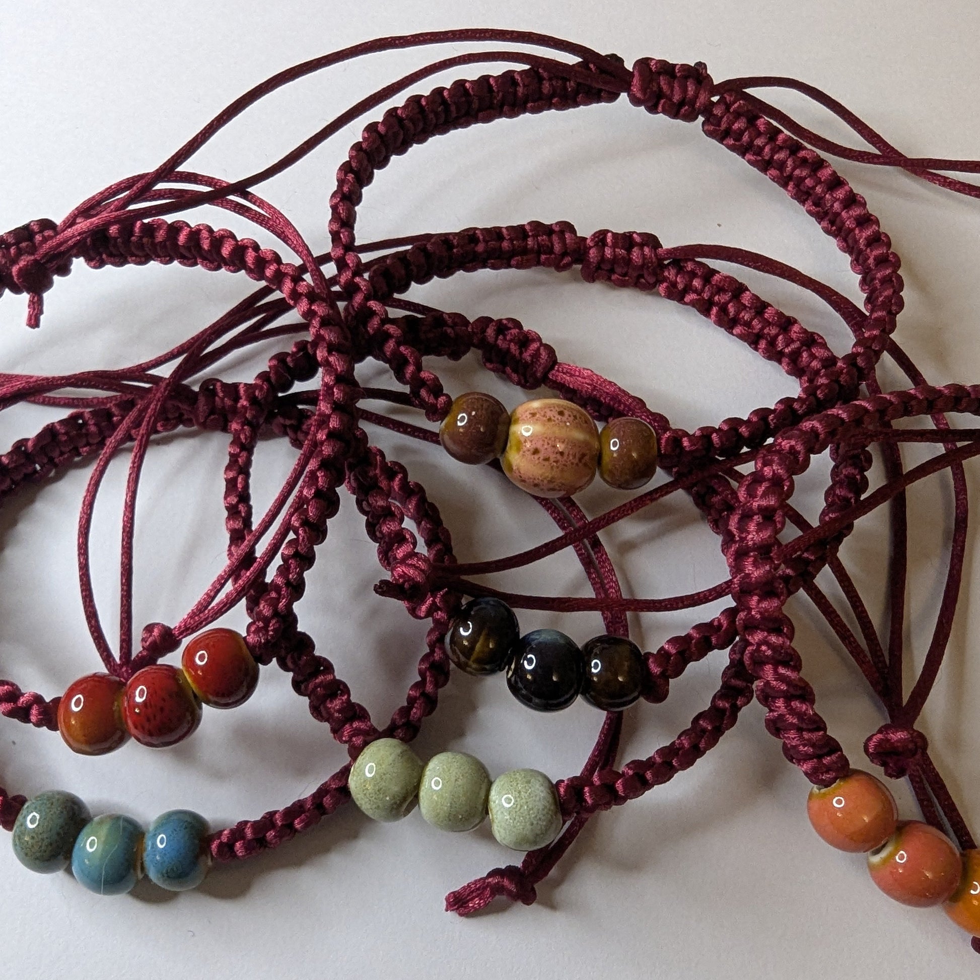 Multiple macrame bracelets with colourful ceramic beads 